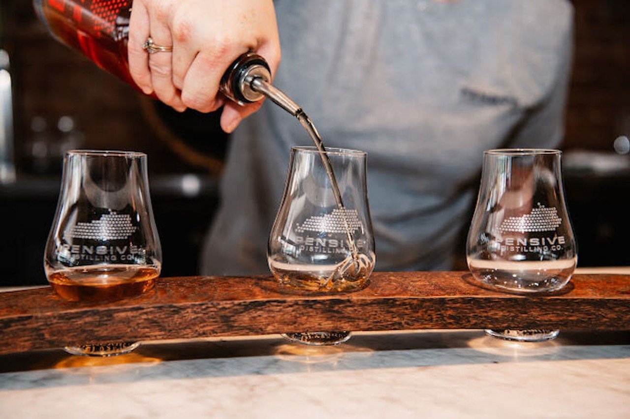 Bourbon gets poured into a glass.