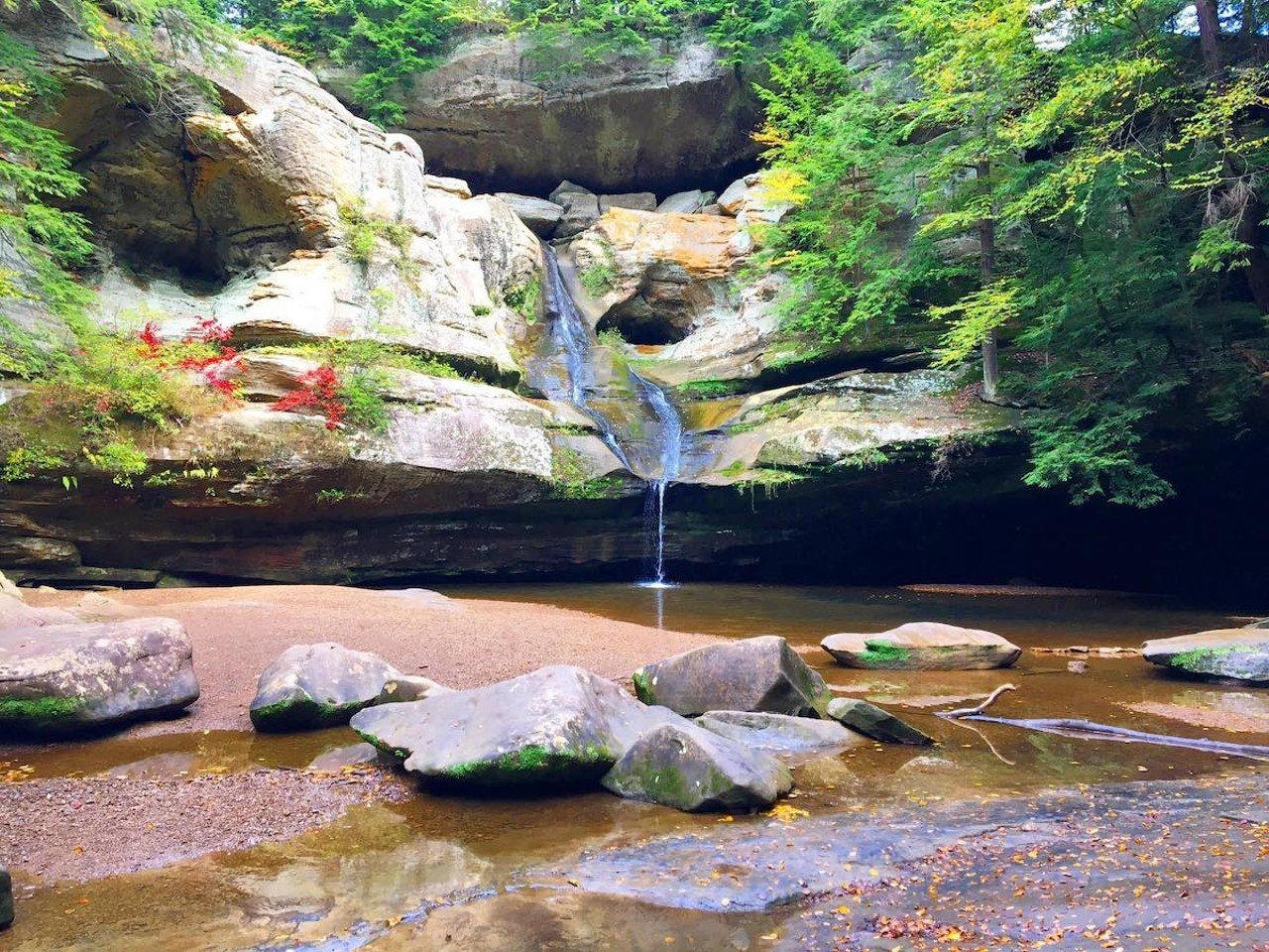 Hocking Hills, Ohio
Distance: 2 hours and 30 minutes 
Voted as one of the best places to see fall colors, the Hocking Hills region is a must-do trip in autumn. Hocking Hills State Park offers seven trail systems with beautiful sites like the waterfalls at Cedar Falls and Old Man’s Cave, the rocky arches of Rock House and the gorges of Ash Cave. Outside the park are even more trail systems, including Airplane Rock, Conkles Hollow and Zaleski State Forest — which is a must-visit if you want to add a little spookiness to your trip: Nearby is the Moonville Tunnel, once part of the Marietta and Cincinnati (M&C) Railroad and one of the few remainders of the ghost town of Moonville. (It’s also allegedly haunted). To unwind after a day of exploring, be sure to visit Logan, Ohio’s Hocking Hills Winery for a glass of wine and a charcuterie board, or fuel up for your day of hiking, climbing or kayaking with a delicious breakfast sandwich at the fantastic Coffee Emporium (no relation to Cincinnati’s own Coffee Emporiums).