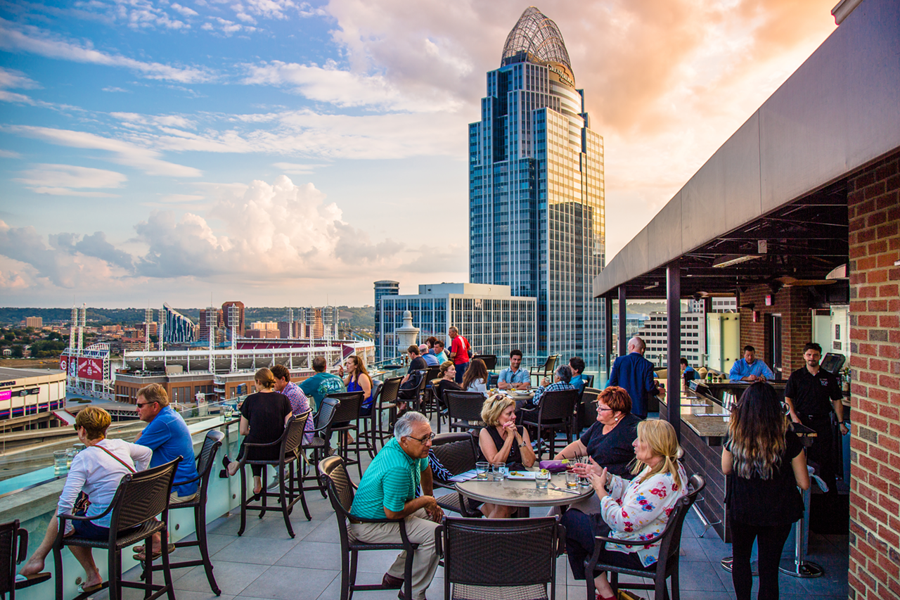 Top of the Park
506 E. Fourth St., Downtown
For a stunning, nearly-360-degree view of downtown Cincinnati and its riverfront, plus some amazing craft cocktails, snag the elevator in the lobby of The Phelps hotel and take it to the very top where you’ll find one of the best rooftop bars in the city. The seasonal Top of the Park is intimate, with plenty of comfy seating, including a glass bar top where you can sit with your drink and enjoy the bird’s-eye view. Grab a Rooftop Lemonade (Ketel One Citroen, muddled strawberries, fresh lemon juice and wild berry simple syrup) and toast to the amazing sights.