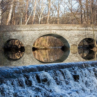 Sharon Woods11450 Lebanon Road, SharonvilleThere’s no need to drive too far if you want to hike to a waterfall in Ohio. Great Parks’ Sharon Woods in Sharonville is home to several along its Gorge Trail. This moderate-level, out-and-back trail stretches about 0.7 miles one way. You start the hike at Sharon Lake and follow the creek, where you’ll spot several small waterfalls. As you take in their beauty, you’ll notice the alternating layers of shale and limestone rock in the gorge. These rocks are filled with fossils that date back to the Ordovician period – about 450 million years ago. The park also boasts a 2.6-mile paved, multipurpose trail around Sharon Lake and a 1-mile fitness trail.