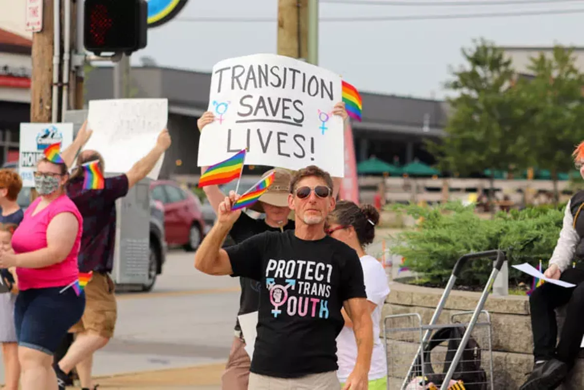 A demonstrator marches at a rally for LGBTQ+ people in Cincinnati.