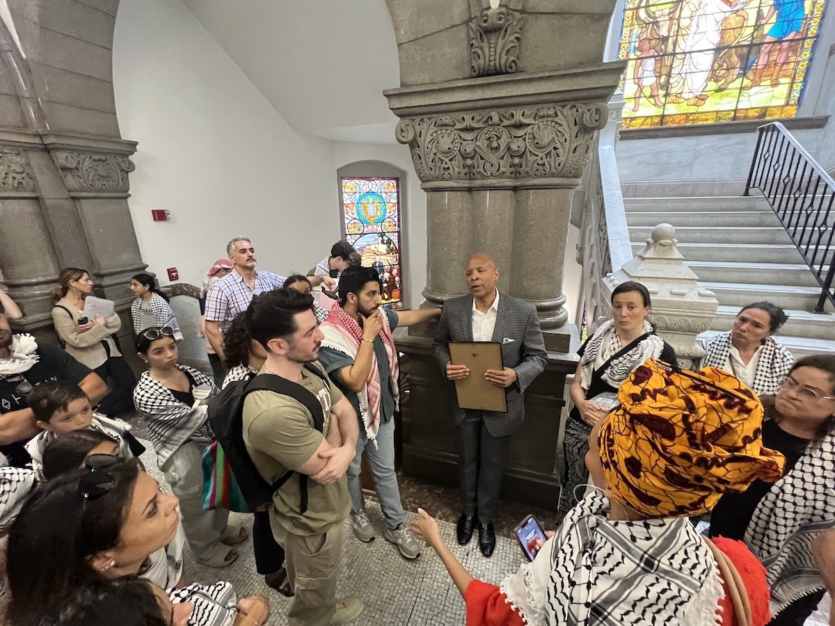 Cincinnati City Council member Scotty Johnson talks with pro-Palestinian gallery members after a World Keffiyeh Day resolution was passed with a controversial amendment.