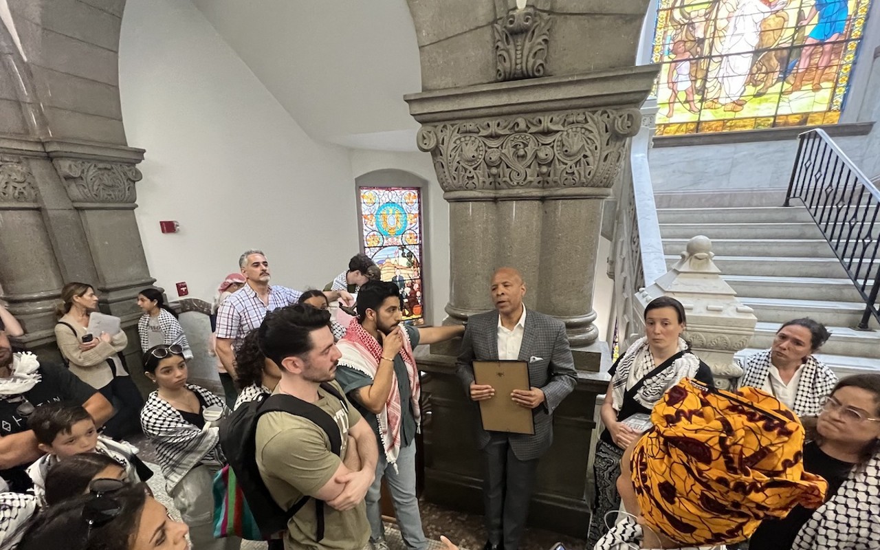 Cincinnati City Council member Scotty Johnson talks with pro-Palestinian gallery members after a World Keffiyeh Day resolution was passed with a controversial amendment.