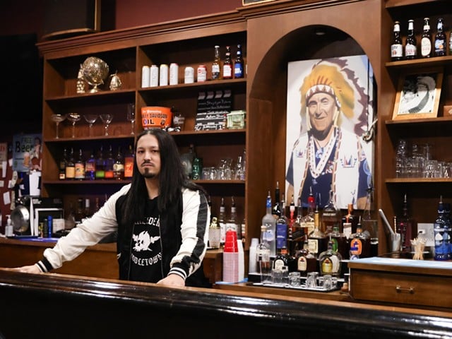 Josh Mack, co-owner of The Lakeside Inn, stands behind the bar