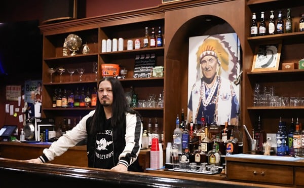 Josh Mack, co-owner of The Lakeside Inn, stands behind the bar