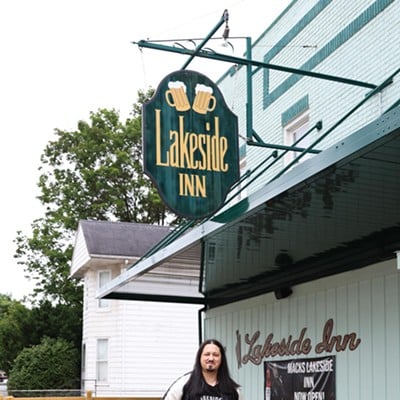 The owner, Brian Mack, poses outside of the Lakeside Inn bar in Middletown