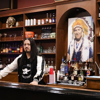 The owner, Brian Mack, poses inside the Lakeside Inn bar in Middletown