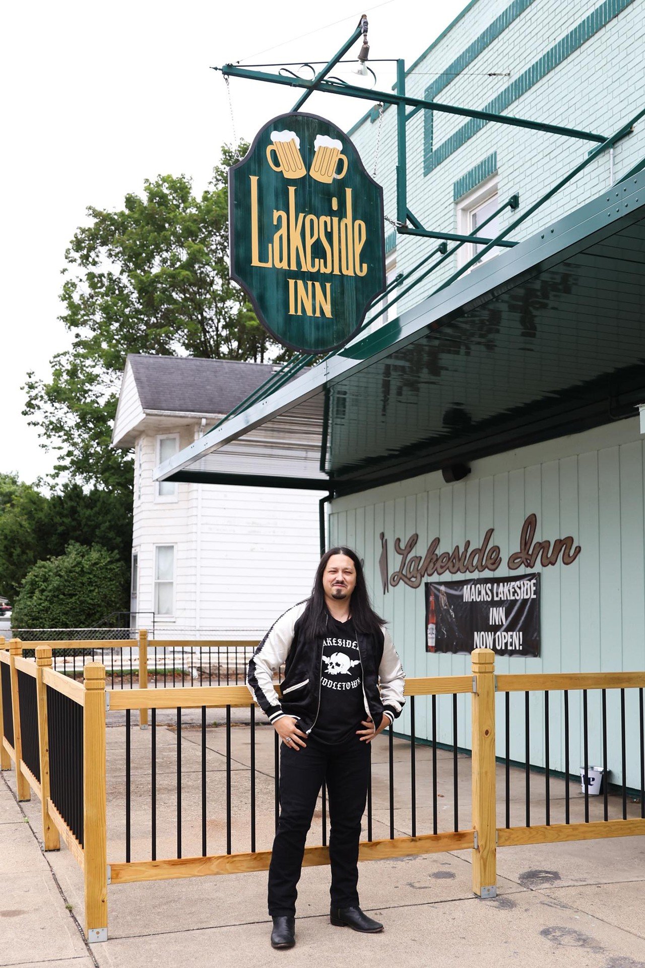 The owner, Brian Mack, poses outside of the Lakeside Inn bar in Middletown