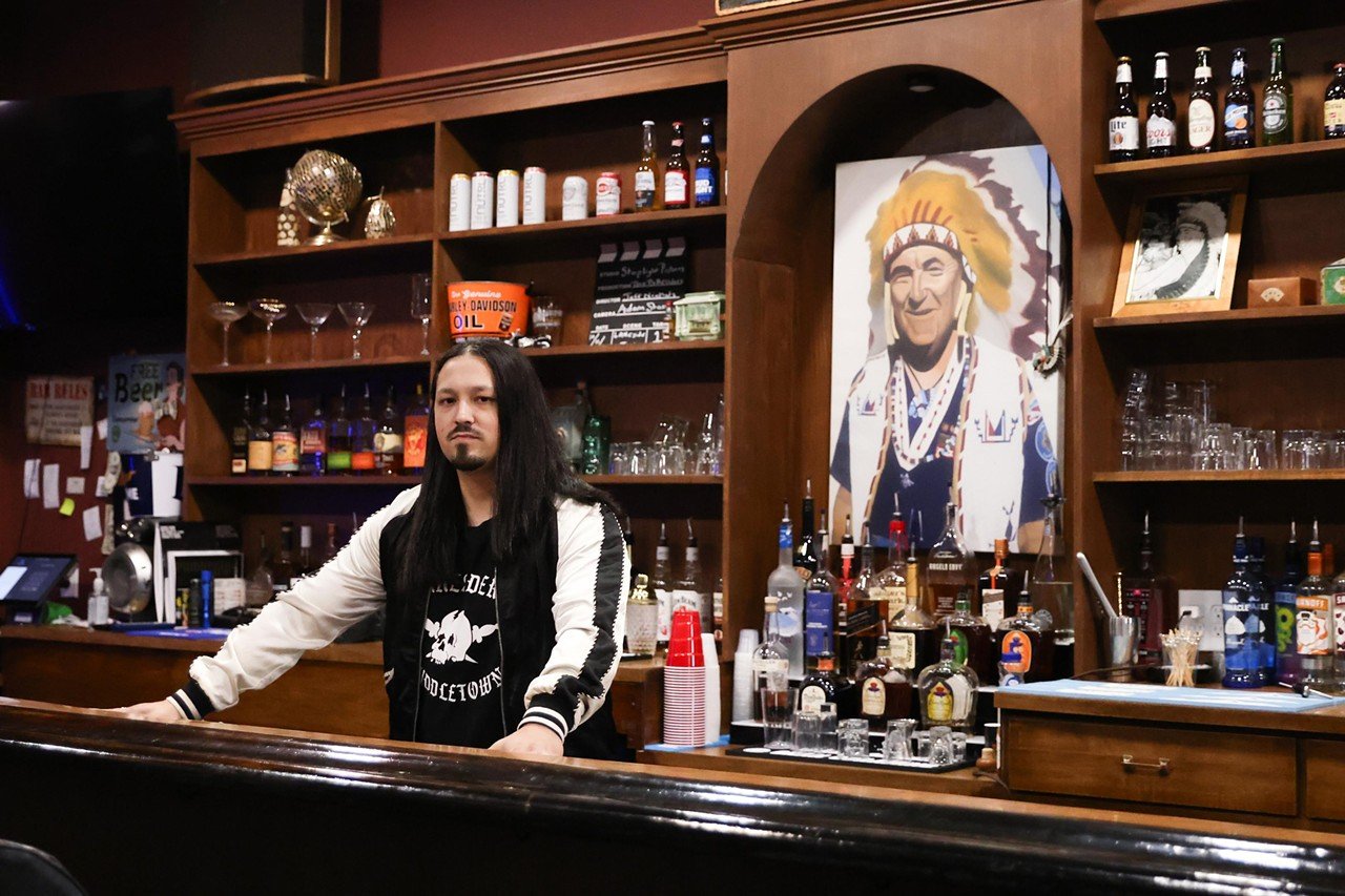 The owner, Brian Mack, poses inside the Lakeside Inn bar in Middletown