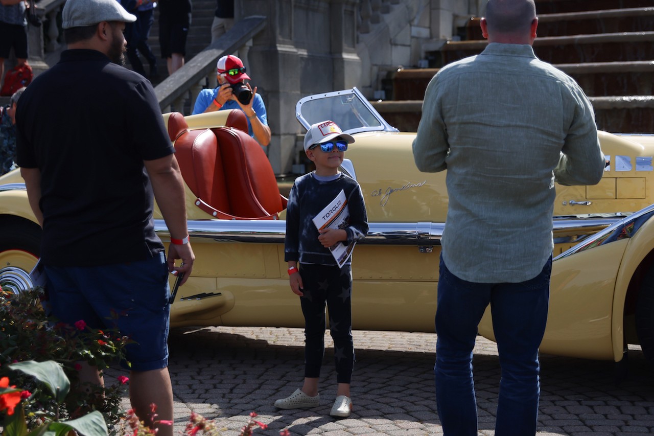 A young child poses for a photo at the 46th annual Cincinnati Concours d’Elegance car show on Sunday, June 9, 2024.