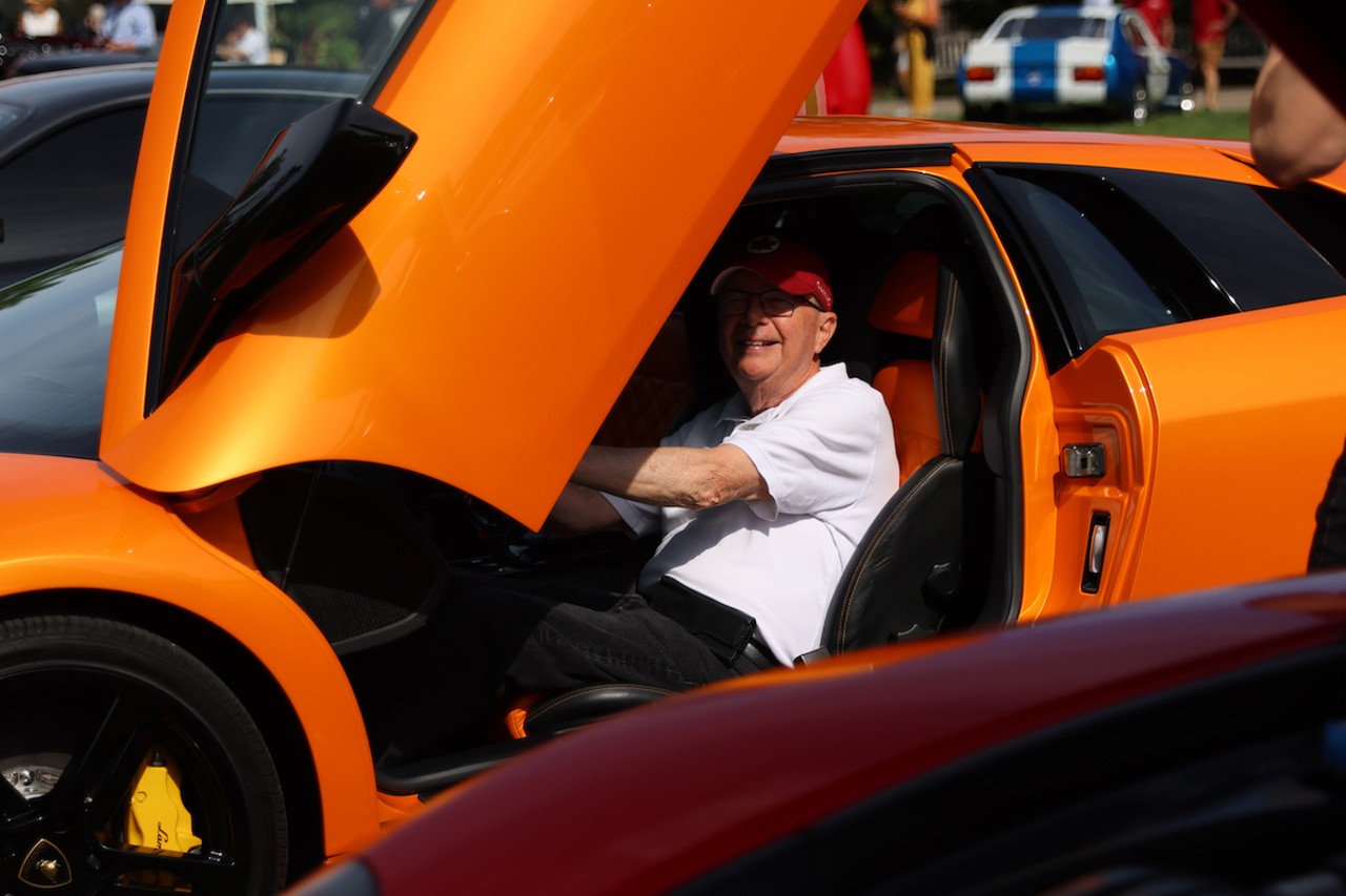 An attendee sits in a car at the 46th annual Cincinnati Concours d’Elegance car show on Sunday, June 9, 2024.