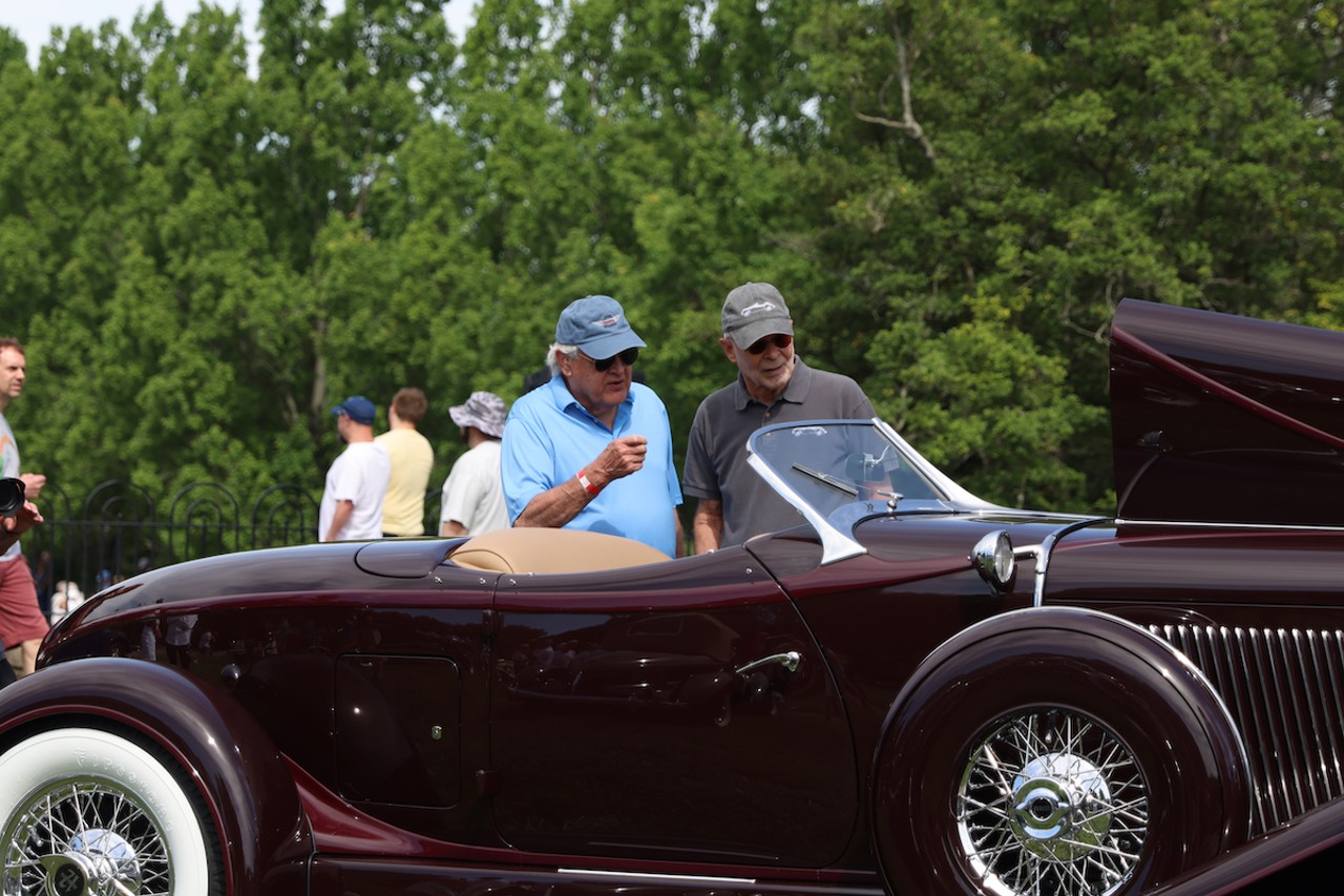 Attendees inspect a car at the 46th annual Cincinnati Concours d’Elegance car show on Sunday, June 9, 2024.