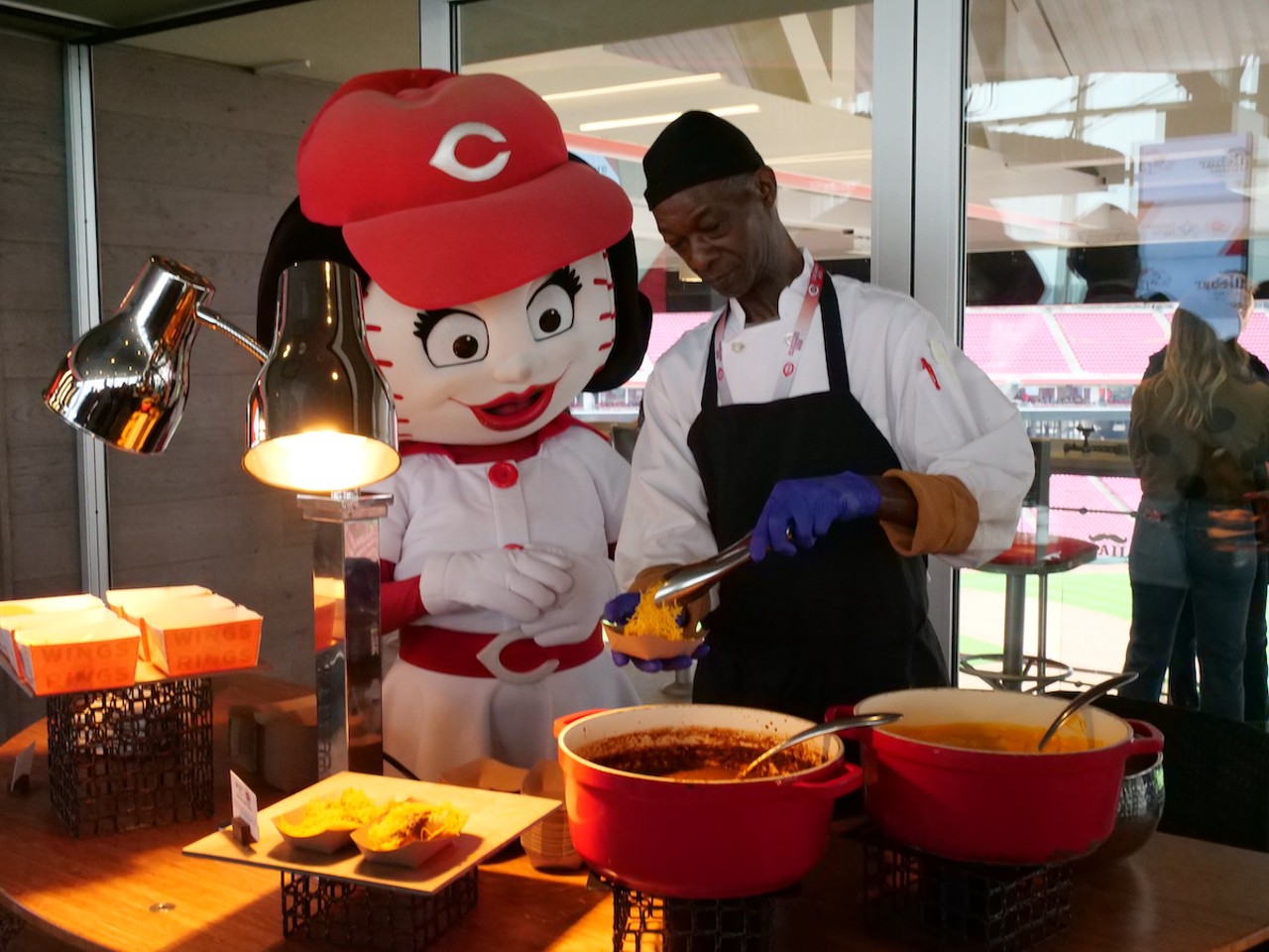 The Reds introduce new food options at Great American Ball Park on March 23, 2023, ahead of the Cincinnati Reds' 2023 season. Rosie Red and a friend serve up Skyline Chili nachos.