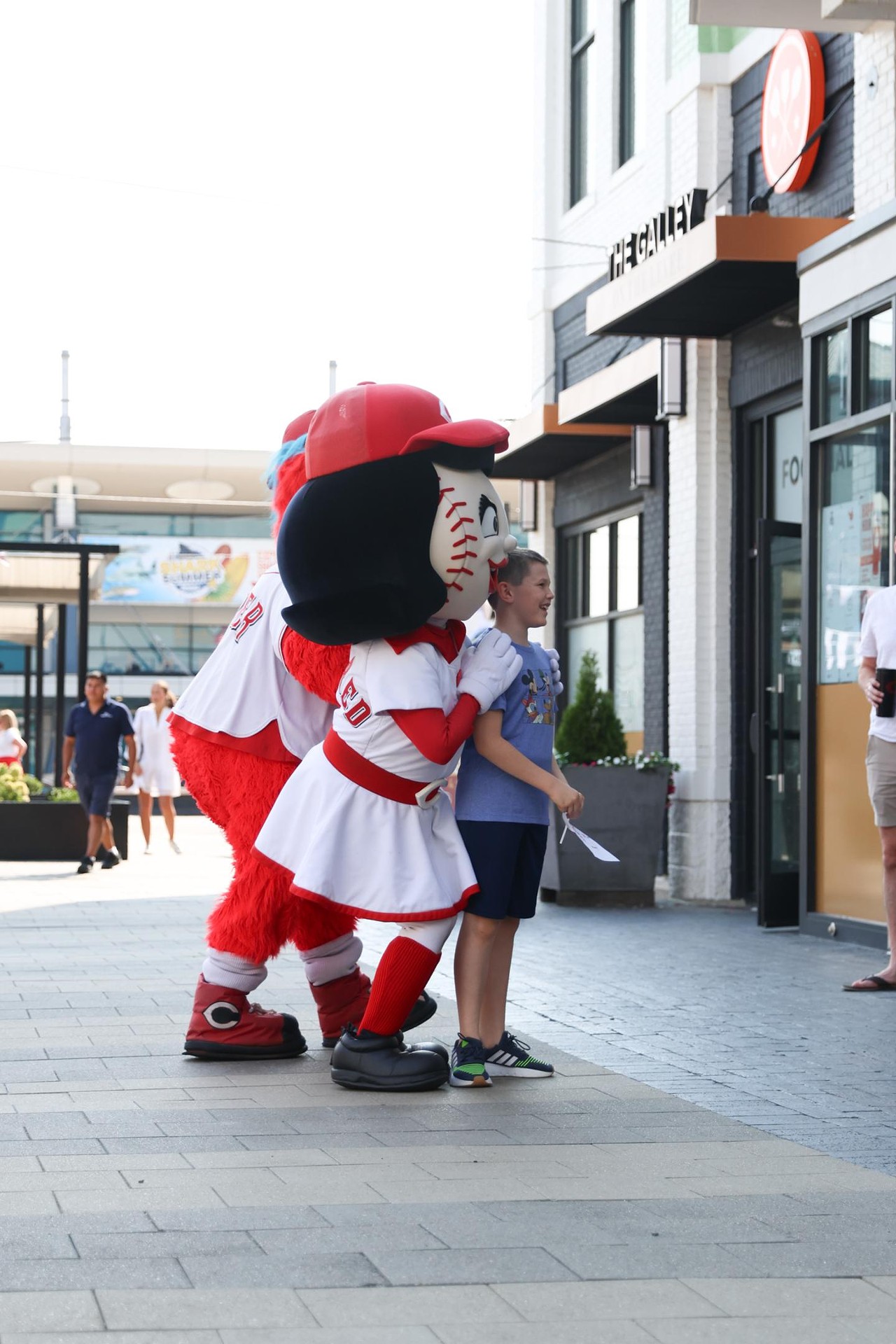 Rosie Red and Gapper take a photo with a young fan at the Olympic Opening Ceremony celebration at Newport on the Levee on Friday, July 26, 2024.