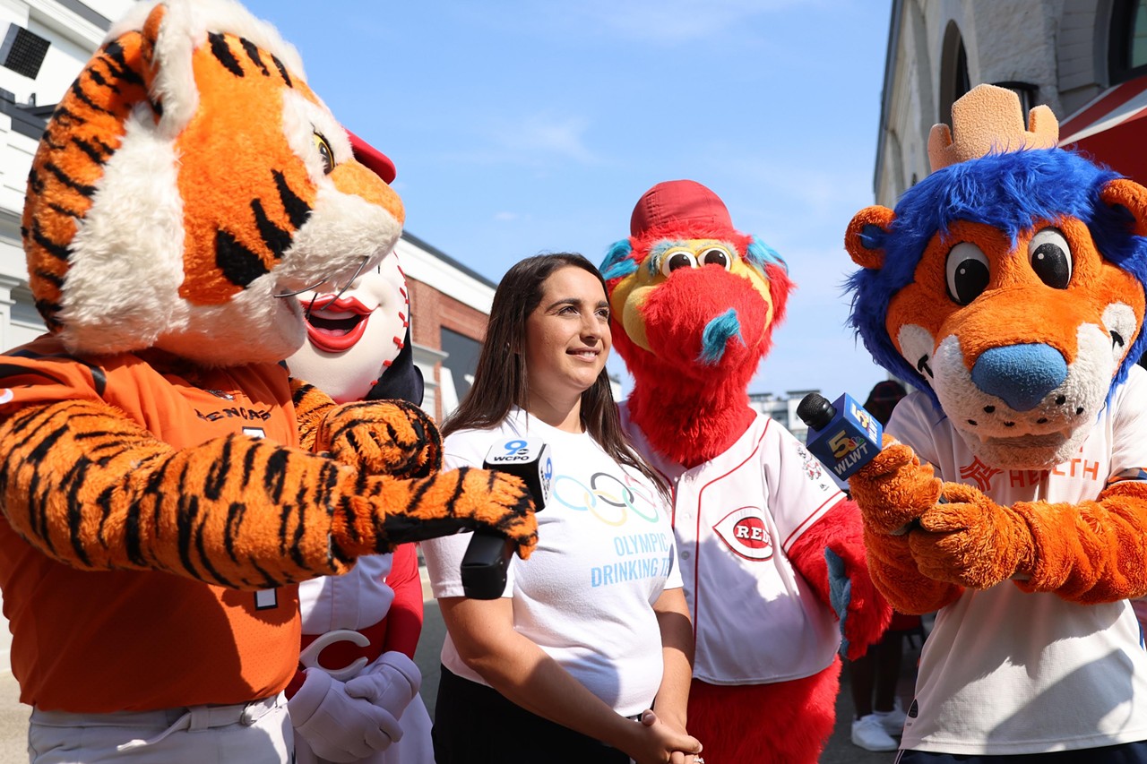 Cincinnati mascots help local news interview people at the Olympic Opening Ceremony celebration at Newport on the Levee on Friday, July 26, 2024.