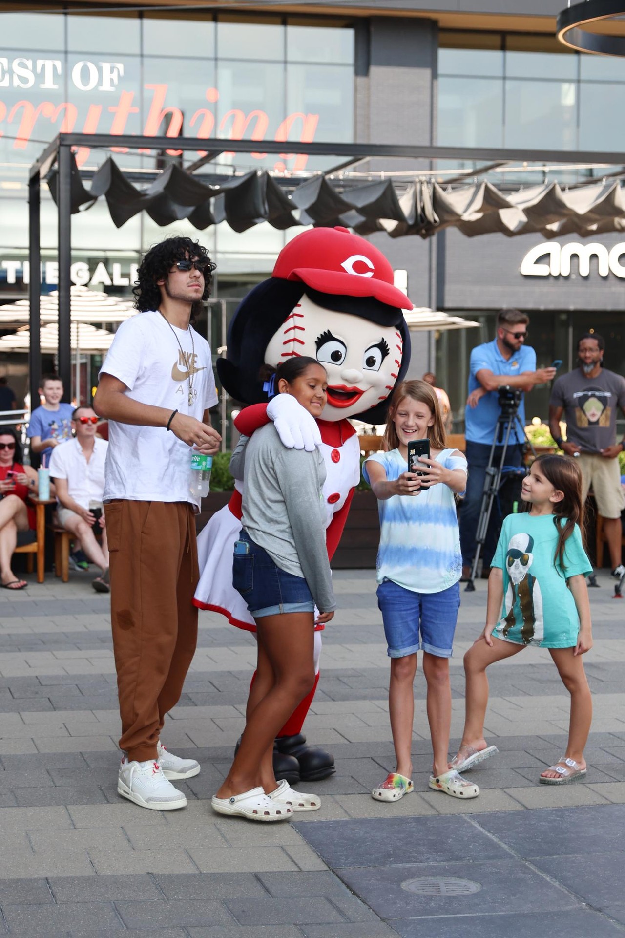 Rosie Red takes a selfie with a fan at the Olympic Opening Ceremony celebration at Newport on the Levee on Friday, July 26, 2024.