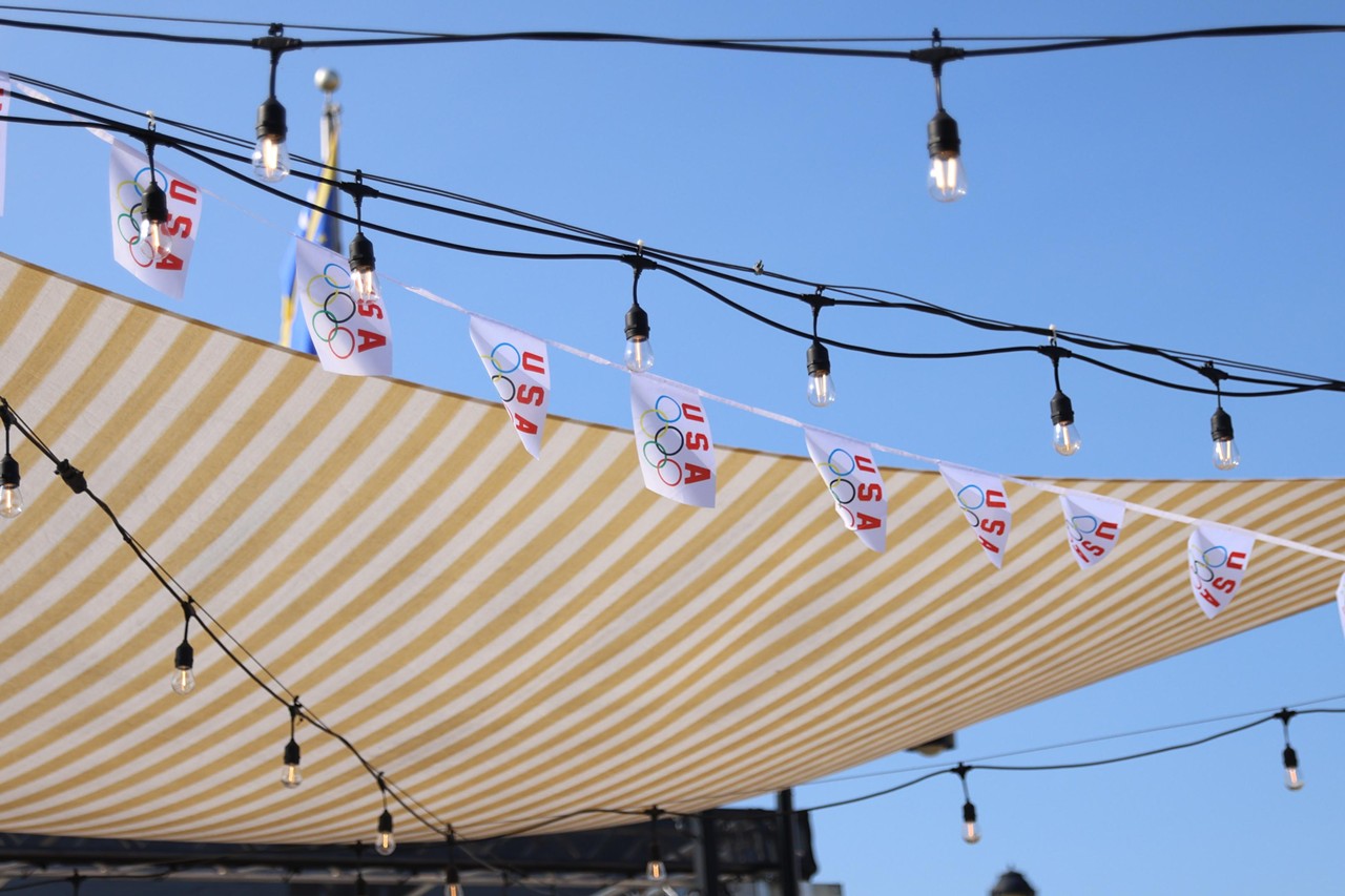 Flags hang at the Olympic Opening Ceremony celebration at Newport on the Levee on Friday, July 26, 2024.