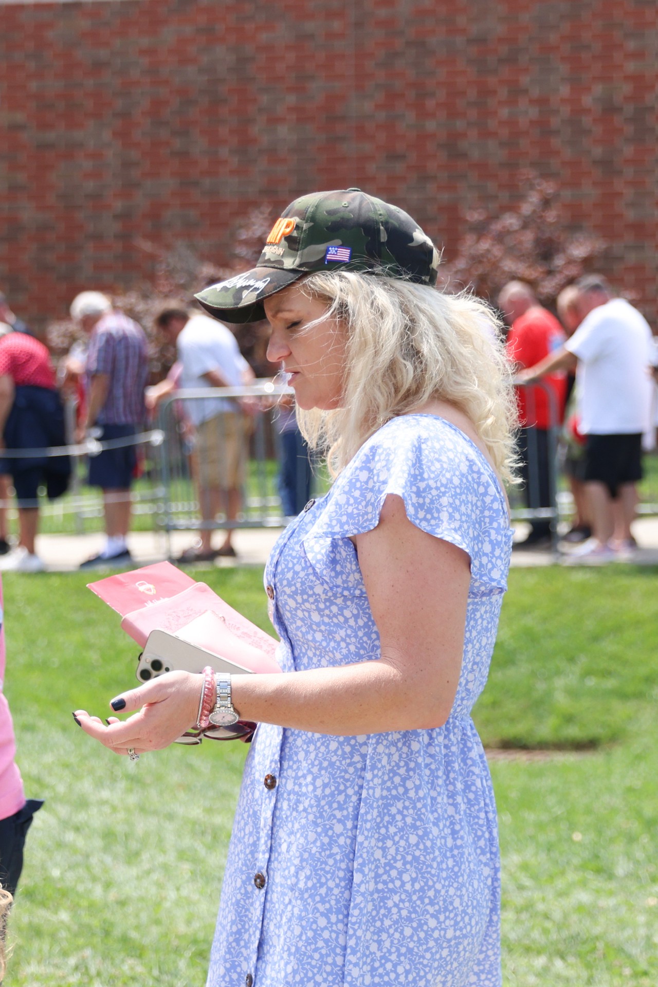 A Trump-Vance supporter prays before entering Middletown High School for Vance's July 22 campaign rally.