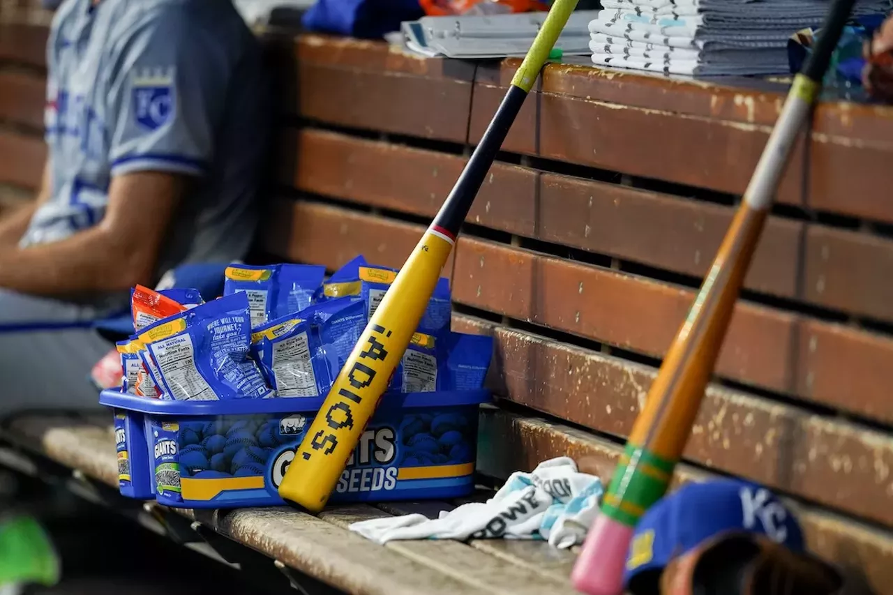 A bat sits among the Kansas City Royals in the dugout | Cincinnati Reds vs. Kansas City Royals | Aug. 17, 2024