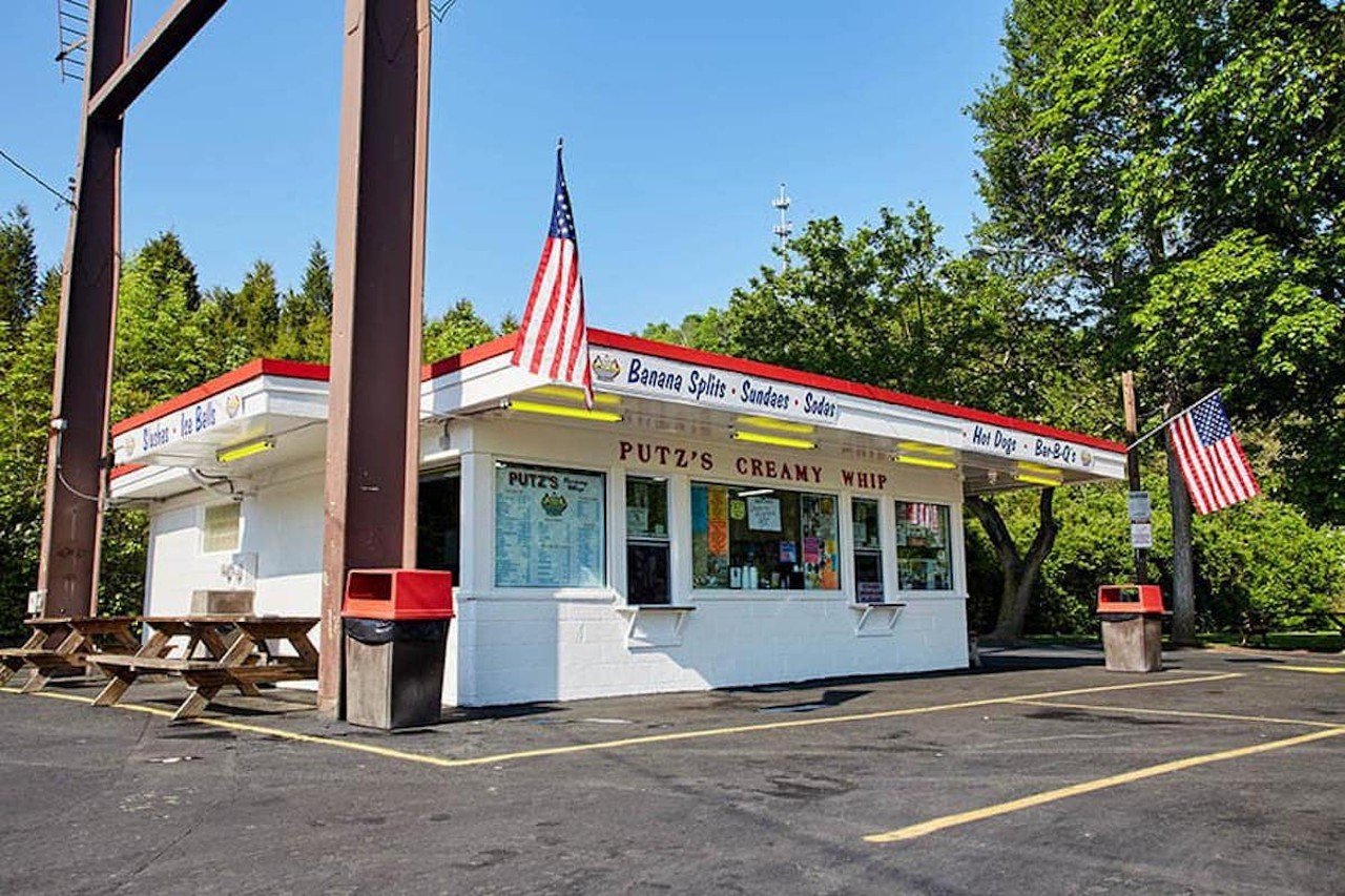 Putz’s Creamy Whip
2673 Putz Place, East Westwood/Northside
Putz’s Creamy Whip has been in the family since the day Constantine and Anna Putz opened their first trolley car walk-up ice cream window in 1938. The Putz as we know it — now in a square concrete structure just down the hill from Mt. Airy Forest — is a scoop of summer nostalgia served with a smile. Not much about this place has changed over the past several decades. Putz descendants have been cranking out cones at the creamy whip for the last few decades — all on the same Electro-Freeze machine. Another tradition? Putz’s is cash-only. Despite the hoopla about the vintage ice cream machine and vanilla soft-serve, the pineapple sherbet is a must. It’s creamy like soft-serve and tangy to boot. “Face cones” are also a hot commodity at Putz’s. The soft-serve cones are adorned with Necco wafer ears and crunchy googly-eyed candy.