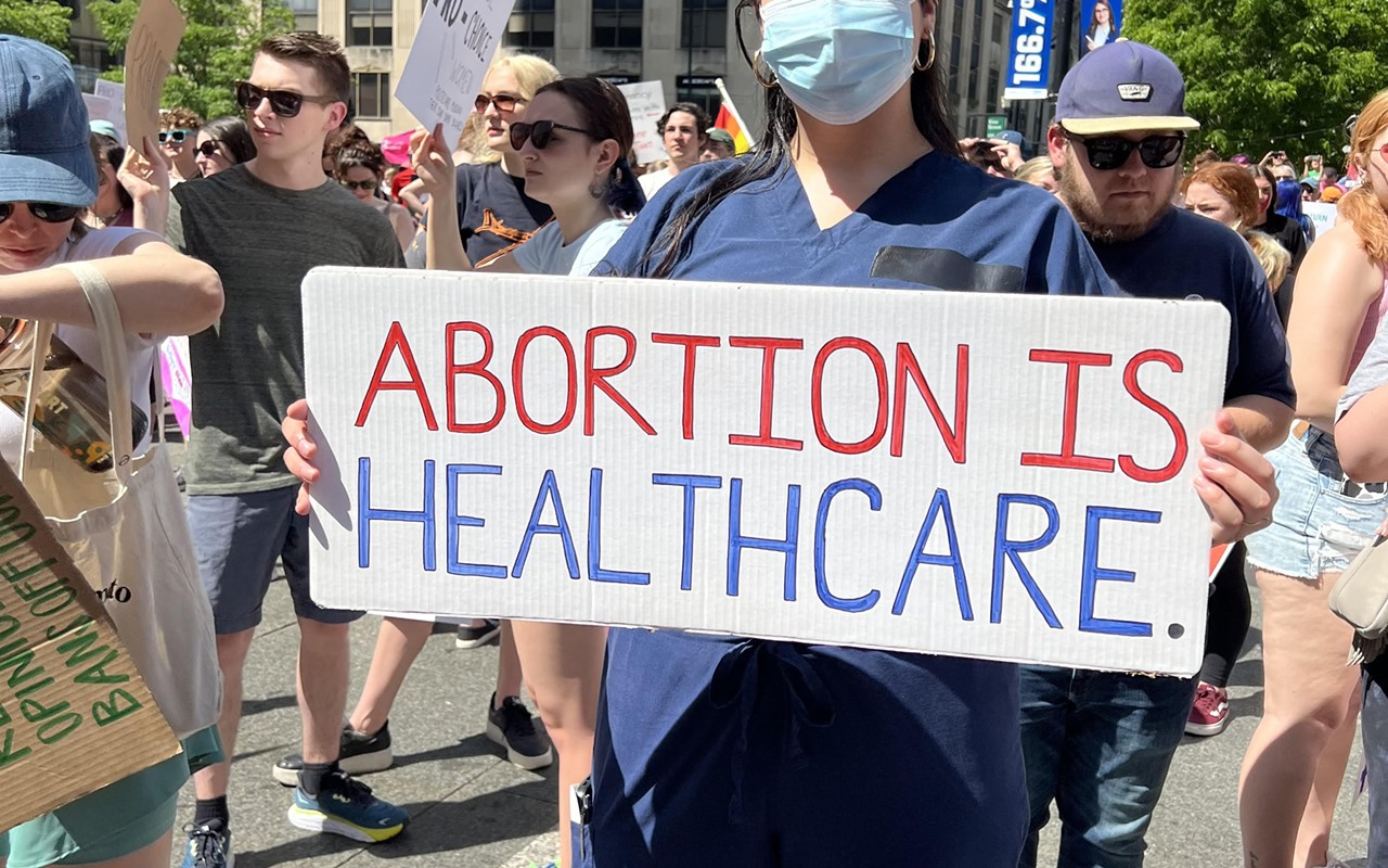 A nurse holds a sign in support of abortion access at a Planned Parenthood rally in Downtown Cincinnati on May 15, 2022.