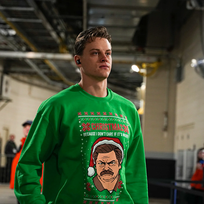 Cincinnati Bengals quarterback Joe Burrow wears a sweatshirt featuring Parks & Recreation character Ron Swanson before the game against the New England Patriots on Dec. 24, 2022.