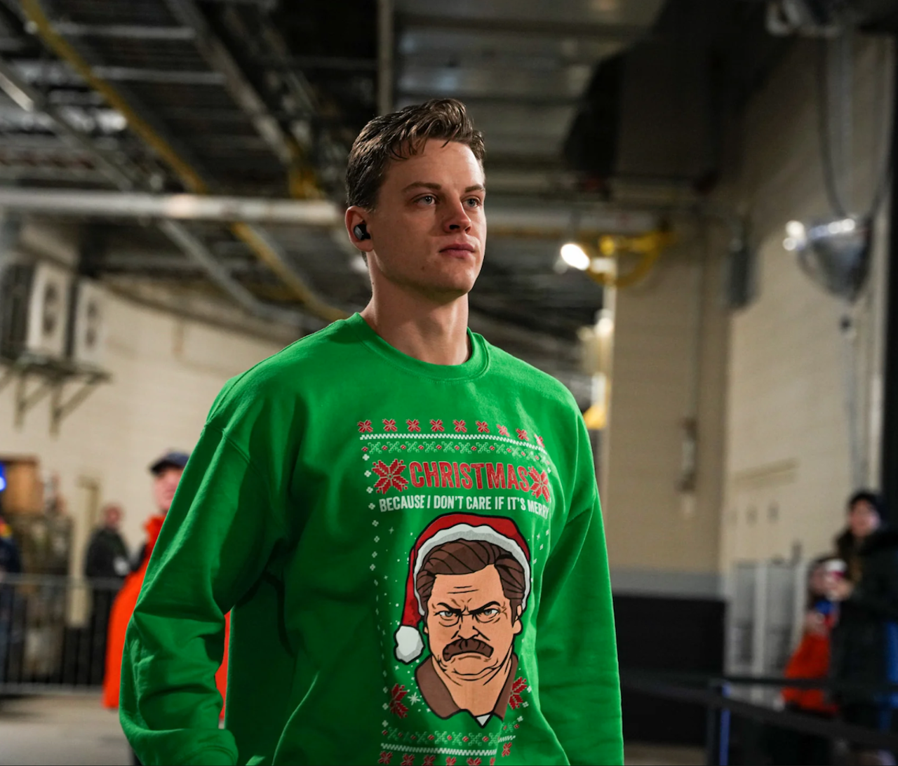 Cincinnati Bengals quarterback Joe Burrow wears a sweatshirt featuring Parks & Recreation character Ron Swanson before the game against the New England Patriots on Dec. 24, 2022.