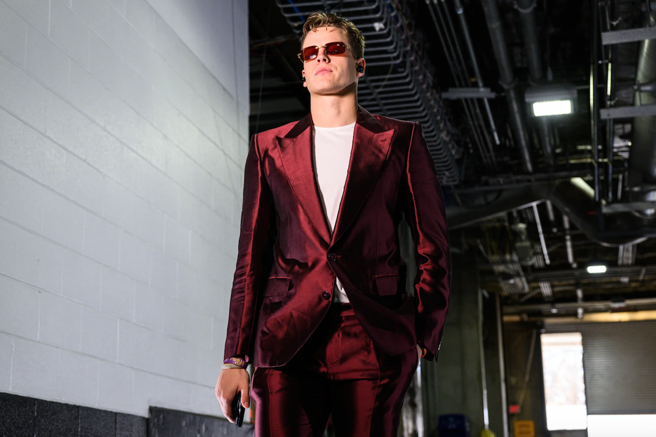 Cincinnati Bengals quarterback Joe Burrow wears a red velvet suit and ruby sunglasses before the game against the Kansas City Chiefs on Dec. 4, 2022.