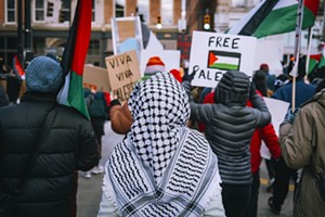 A protester wears a keffiyeh at a solidarity rally for Palestine held at Cincinnati's Ziegler Park on Jan. 13, 2023. - Photo: Aidan Mahoney